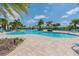 Community pool with surrounding lounge chairs and palm trees at 16039 Juniper Inlet Aly, Winter Garden, FL 34787