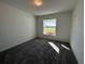 Well-lit bedroom with carpet flooring and a large window at 2177 Emma Ln, Lake Wales, FL 33859