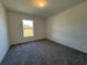 Well-lit bedroom with carpet flooring and a large window at 2177 Emma Ln, Lake Wales, FL 33859