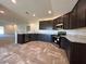 Modern kitchen with dark cabinetry, granite countertops, and stainless steel appliances at 2177 Emma Ln, Lake Wales, FL 33859