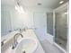 Bathroom featuring double sinks, large mirror, and glass enclosed shower at 2181 Emma Ln, Lake Wales, FL 33859