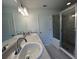 Elegant bathroom featuring double sinks, modern fixtures, and glass-enclosed shower at 2181 Emma Ln, Lake Wales, FL 33859