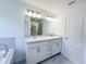 Bathroom vanity with double sinks, chrome faucets, and white cabinets at 2181 Emma Ln, Lake Wales, FL 33859