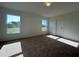 Sunlit bedroom with carpeted flooring, two windows, and a closet at 2181 Emma Ln, Lake Wales, FL 33859