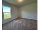 Bedroom featuring plush carpet, ample natural light from the window, and fresh white walls at 2181 Emma Ln, Lake Wales, FL 33859