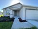 Attractive home showcasing a covered front porch and landscaped garden beds leading to the entry at 2181 Emma Ln, Lake Wales, FL 33859