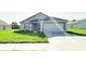 Charming single-story home with a well-manicured lawn and attached two-car garage at 2181 Emma Ln, Lake Wales, FL 33859