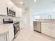 Kitchen includes stainless steel appliances, light countertops, and tile floors at 2181 Emma Ln, Lake Wales, FL 33859