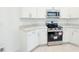 Modern kitchen features white cabinets and stainless steel appliances at 2181 Emma Ln, Lake Wales, FL 33859