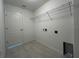 Practical laundry room with tile flooring, wire shelving, and utility sink hookups at 2181 Emma Ln, Lake Wales, FL 33859