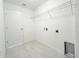 Bright laundry room with tile flooring, shelving, sink and connections for washer and dryer at 2181 Emma Ln, Lake Wales, FL 33859