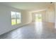 Bright living room with neutral tile flooring, natural light, and sliding glass doors at 2181 Emma Ln, Lake Wales, FL 33859