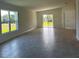 Spacious living room with tiled floors, large windows and glass sliding doors to a lawn at 2181 Emma Ln, Lake Wales, FL 33859
