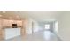 Bright open-concept living space with tile floors connecting to the kitchen and dining areas at 2181 Emma Ln, Lake Wales, FL 33859