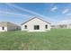 Spacious backyard features a blank canvas for personalization, with a concrete patio and sliding glass doors to the home at 2203 Carson Loop, Lake Wales, FL 33859