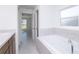 Bathroom featuring bathtub and view to a different room showing spaciousness at 2203 Carson Loop, Lake Wales, FL 33859