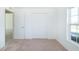 This bedroom features neutral carpeting, a window for natural light, and a closet for ample storage at 2203 Carson Loop, Lake Wales, FL 33859