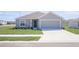 Charming single-Gathering home featuring a well-manicured lawn and attached two-car garage at 2203 Carson Loop, Lake Wales, FL 33859