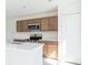 Modern kitchen features stainless steel appliances, wood cabinets, and bright countertops at 2203 Carson Loop, Lake Wales, FL 33859