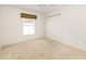 Simple bedroom with neutral decor and double door closet at 2605 Seneca Ave, The Villages, FL 32162