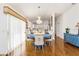 Bright dining room with hardwood floors, chandelier, and blue table at 2605 Seneca Ave, The Villages, FL 32162