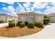 Front view of a single-story house with manicured landscaping at 2605 Seneca Ave, The Villages, FL 32162