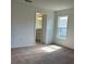 Bedroom featuring carpet and a large doorway to the bathroom at 416 Central Ave, Frostproof, FL 33843