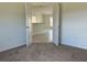 Bedroom view featuring neutral carpet and open doorway to kitchen at 416 Central Ave, Frostproof, FL 33843