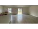 Spacious living room features tile flooring and sliding glass doors to the backyard at 416 Central Ave, Frostproof, FL 33843