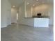 Bright open-concept living space featuring tile floors and a view of the kitchen at 416 Central Ave, Frostproof, FL 33843