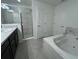 Bright bathroom features a soaking tub and a separate glass-enclosed shower at 418 Central Ave, Frostproof, FL 33843