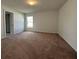 Spacious carpeted bedroom featuring a window and neutral walls, perfect for relaxation at 422 Central Ave, Frostproof, FL 33843