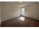 Bright bedroom with neutral carpet, a window, and a closet, ready for personal touches at 422 Central Ave, Frostproof, FL 33843