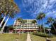 Lakefront condo building with lush landscaping and walkway at 690 Osceola Ave # 308, Winter Park, FL 32789