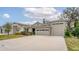 Two-story house with a two-car garage and lush landscaping at 7838 Sloewood Dr, Leesburg, FL 34748