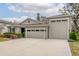 Two-car garage and neatly landscaped front yard at 7838 Sloewood Dr, Leesburg, FL 34748