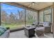 Relaxing screened porch with seating and fire pit overlooking a tranquil backyard at 7838 Sloewood Dr, Leesburg, FL 34748