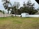 Large backyard with storage shed and privacy fence at 837 Oaks Shores Rd, Leesburg, FL 34748