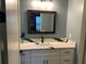 Modern bathroom with a white vanity, quartz countertop, and a large mirror at 837 Oaks Shores Rd, Leesburg, FL 34748