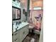 Bathroom boasts a vanity with a quartz countertop, a shower, and stylish decor at 837 Oaks Shores Rd, Leesburg, FL 34748