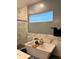 Soaking tub featuring modern fixtures, textured tile, and a large window in the wall for plenty of natural light at 837 Oaks Shores Rd, Leesburg, FL 34748