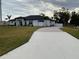 One-story home with a paved driveway and landscaping at 837 Oaks Shores Rd, Leesburg, FL 34748