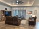 Bright living room featuring tray ceilings, recessed lighting, stylish furniture and light gray walls with modern decor at 837 Oaks Shores Rd, Leesburg, FL 34748