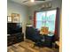 Bright office with a desk, chair, TV, and ample space for work and relaxation at 837 Oaks Shores Rd, Leesburg, FL 34748