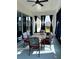 Enclosed patio with comfortable outdoor seating, offering a relaxing view of the backyard at 837 Oaks Shores Rd, Leesburg, FL 34748