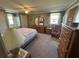 Bedroom with carpeted floor, double bed, and dresser at 110 Dogwood Trl, Leesburg, FL 34748