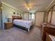 Spacious bedroom with ample closet space and wood furniture at 110 Dogwood Trl, Leesburg, FL 34748