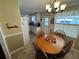 Bright dining area with a round wooden table and four chairs at 110 Dogwood Trl, Leesburg, FL 34748