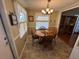 Cozy dining area with round wooden table and four chairs at 110 Dogwood Trl, Leesburg, FL 34748