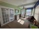 Sunroom with French doors and a workspace at 110 Dogwood Trl, Leesburg, FL 34748